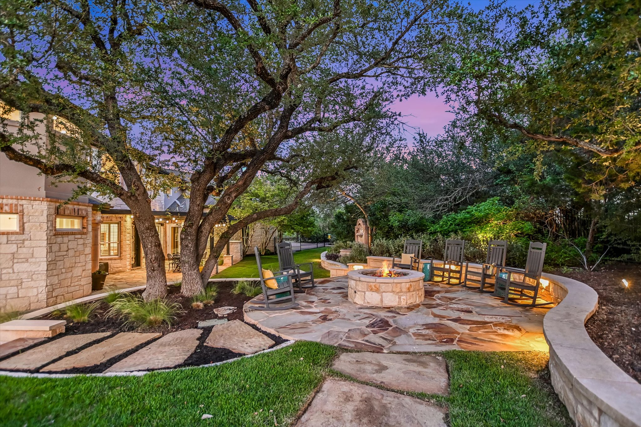 1422 Palomino Ridge Drive Austin, TX 78733 - Photo 44 of 60 a view of a patio with table and chairs under an umbrella