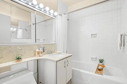 a bathroom with a sink a bath tub and a shower