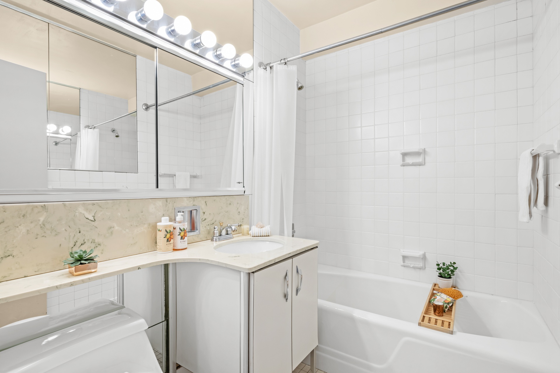 20 East 9th Street, Unit 18E Manhattan, NY 10003 - Photo 21 of 40 a bathroom with a sink a bath tub and a shower
