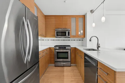 a kitchen with a refrigerator stove and sink