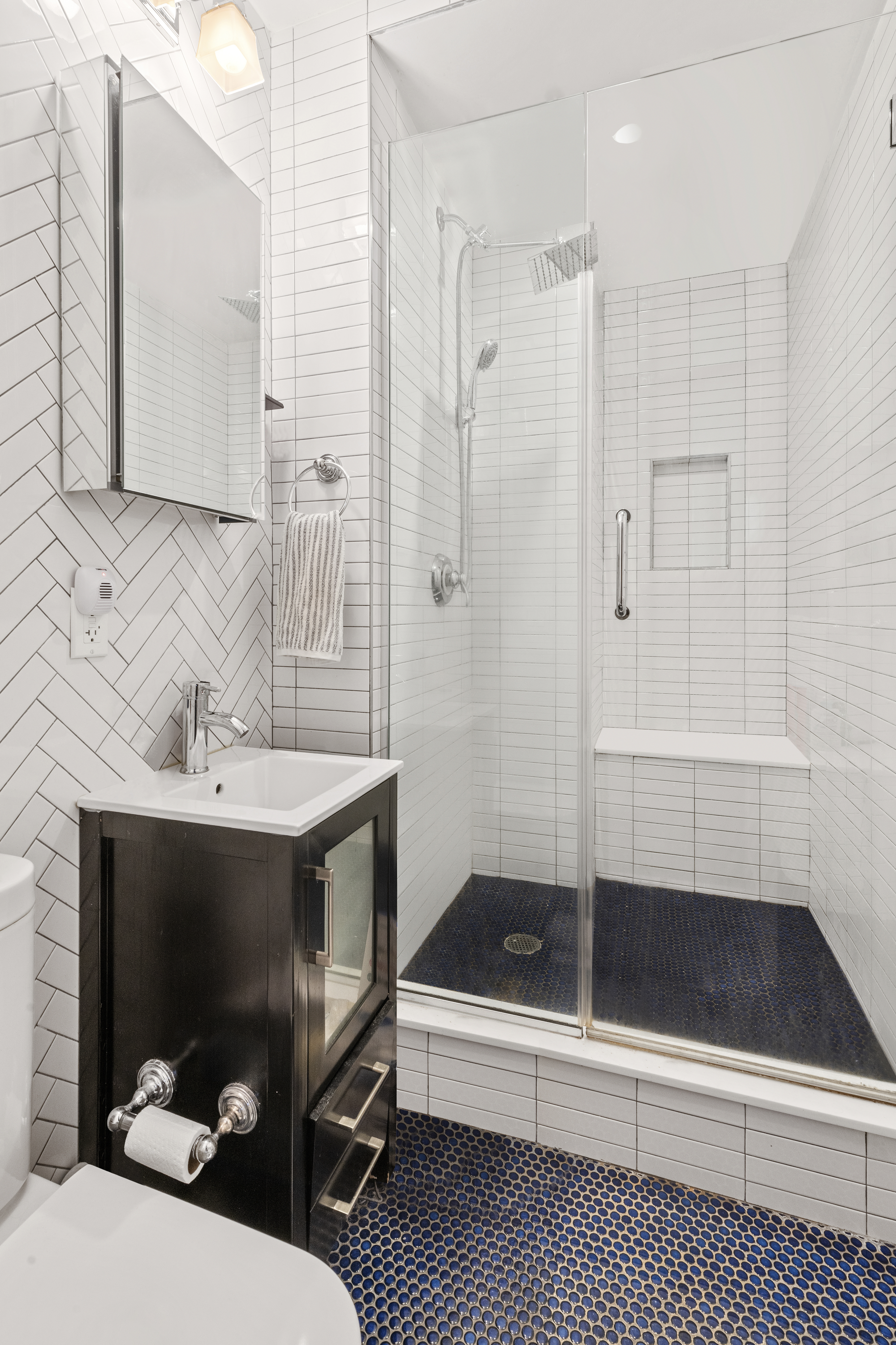 170 West 83rd Street, Unit 2W Manhattan, NY 10024 - Photo 8 of 10 a bathroom with a sink a toilet a mirror and shower
