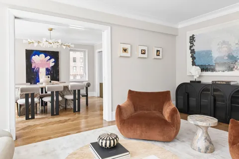a living room with furniture dining table and a window