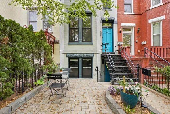 a front view of a house with a garden