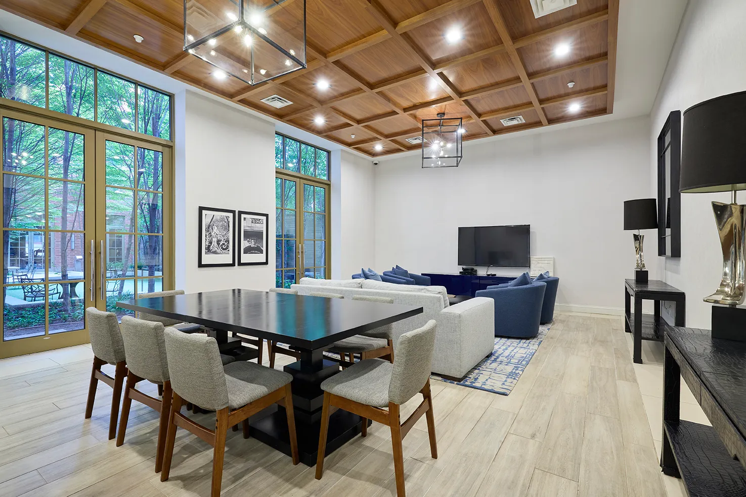 a view of a dining room with furniture a chandelier and wooden floor