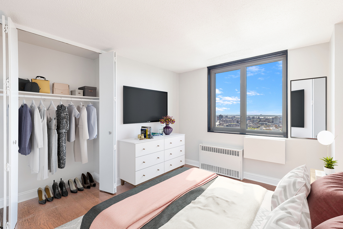 3333 Broadway, Unit E4C Manhattan, NY 10031 - Photo 6 of 23 a bedroom with furniture and flat screen tv