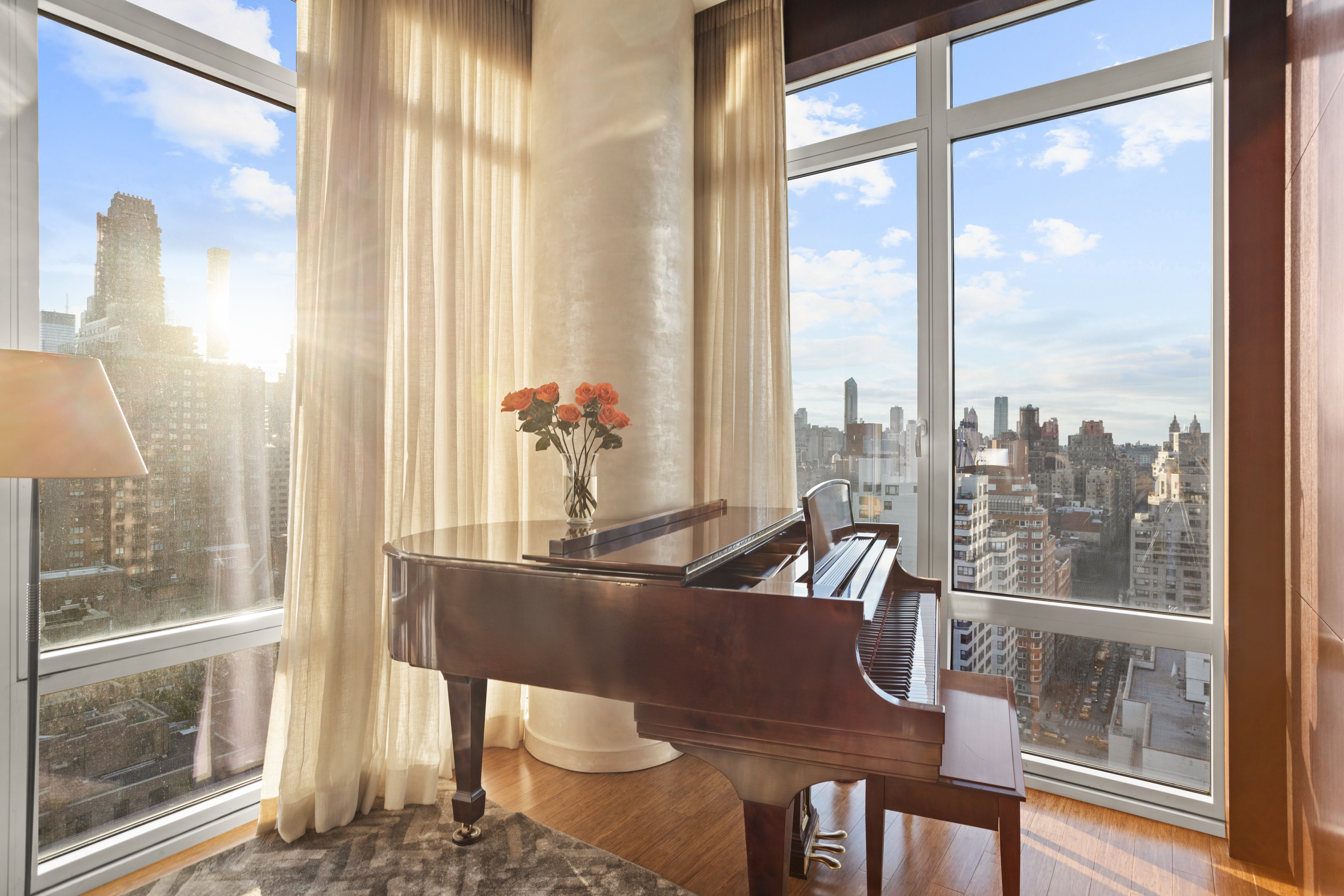 255 East 74th Street, Unit 21AB Manhattan, NY 10021 - Photo 10 of 37 a view of a dining room with furniture large windows and wooden floor