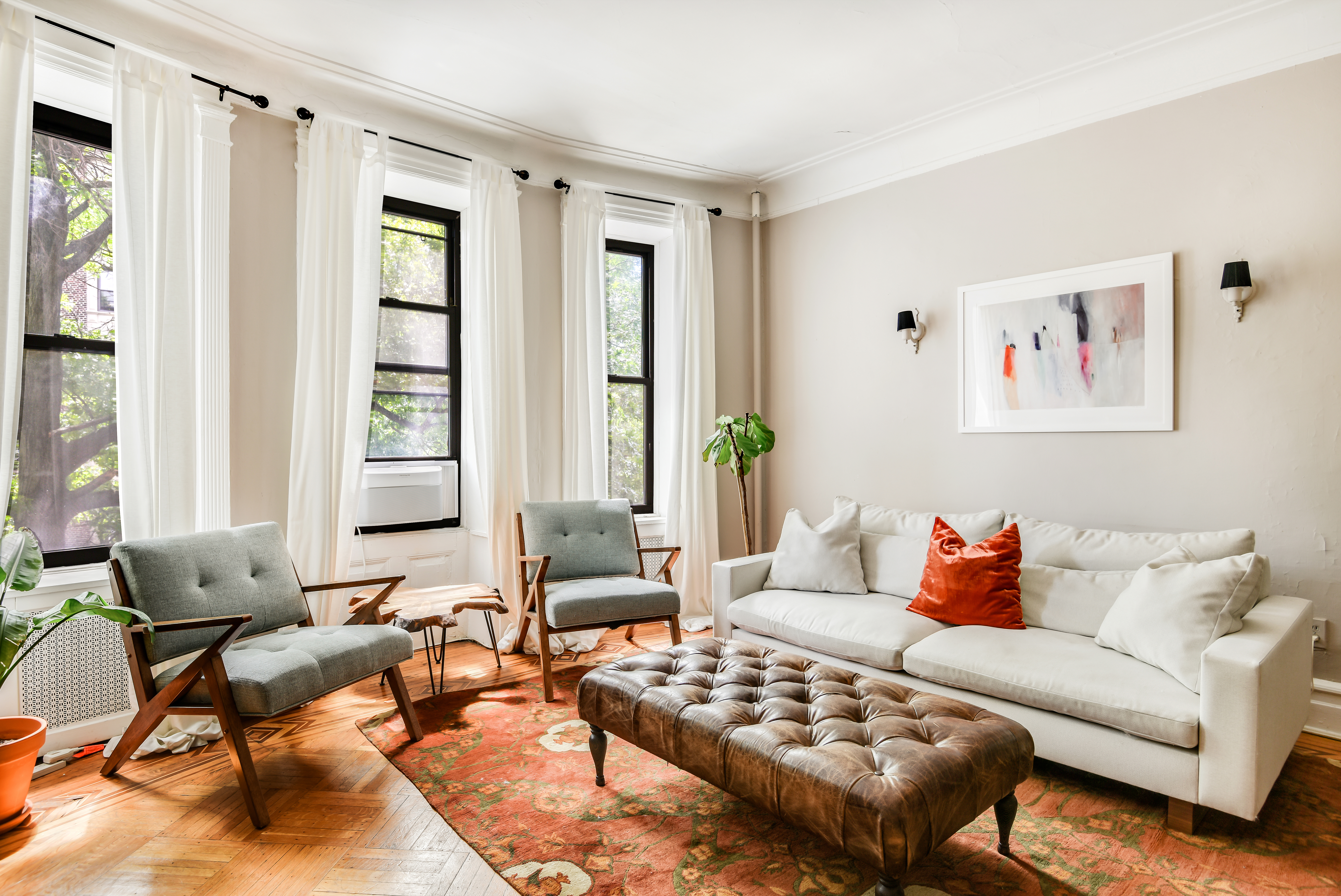 a living room with furniture a rug and a window