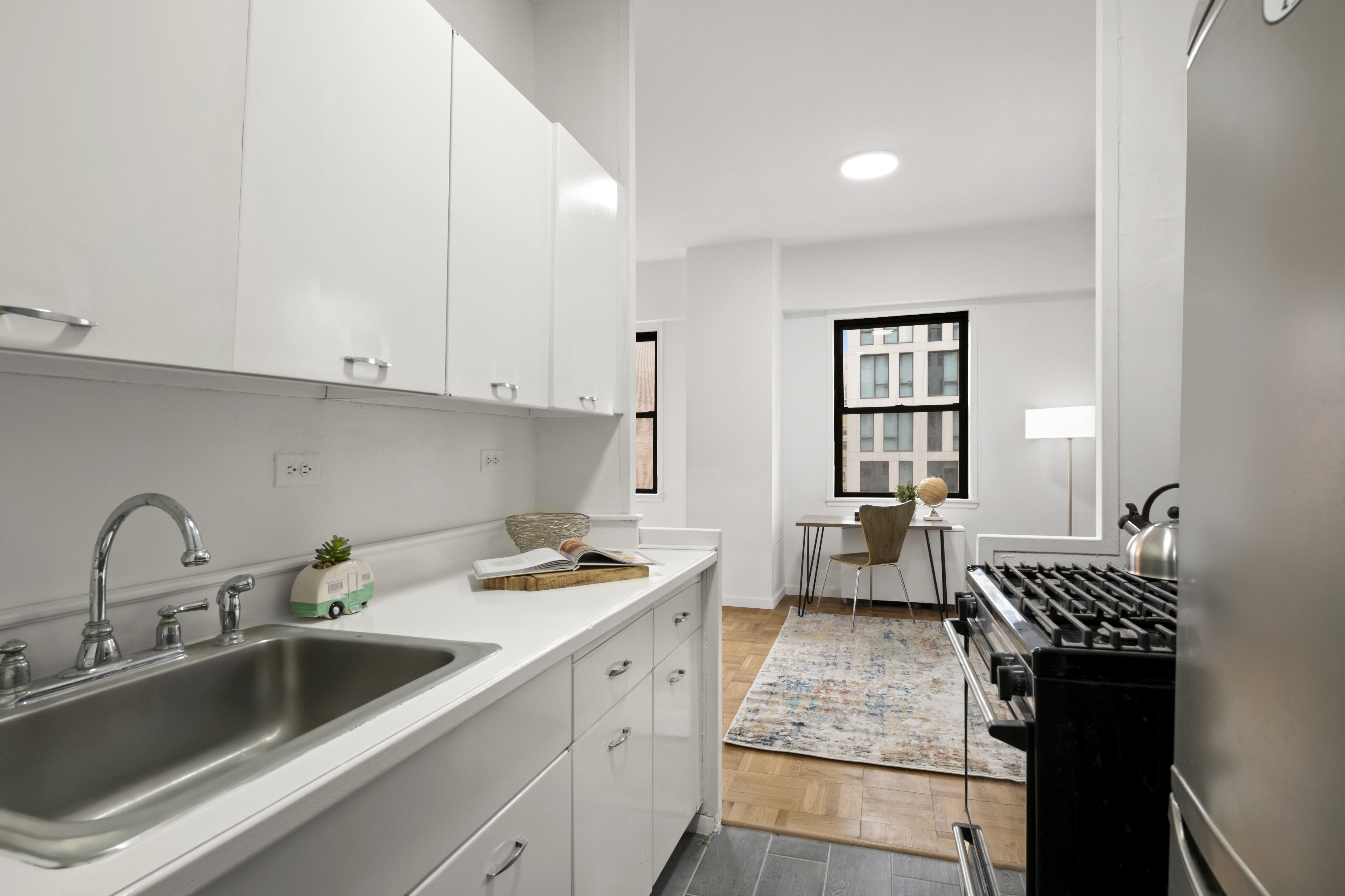 201 East 21st Street, Unit 15C Manhattan, NY 10010 - Photo 4 of 9 a kitchen with a sink and cabinets