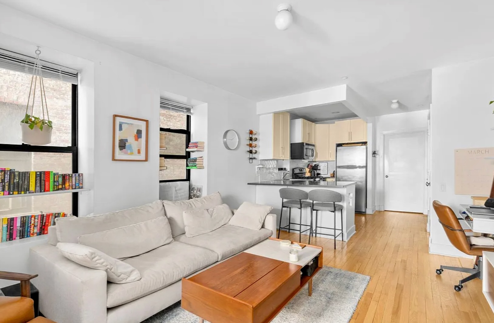 a living room with furniture and a book shelf