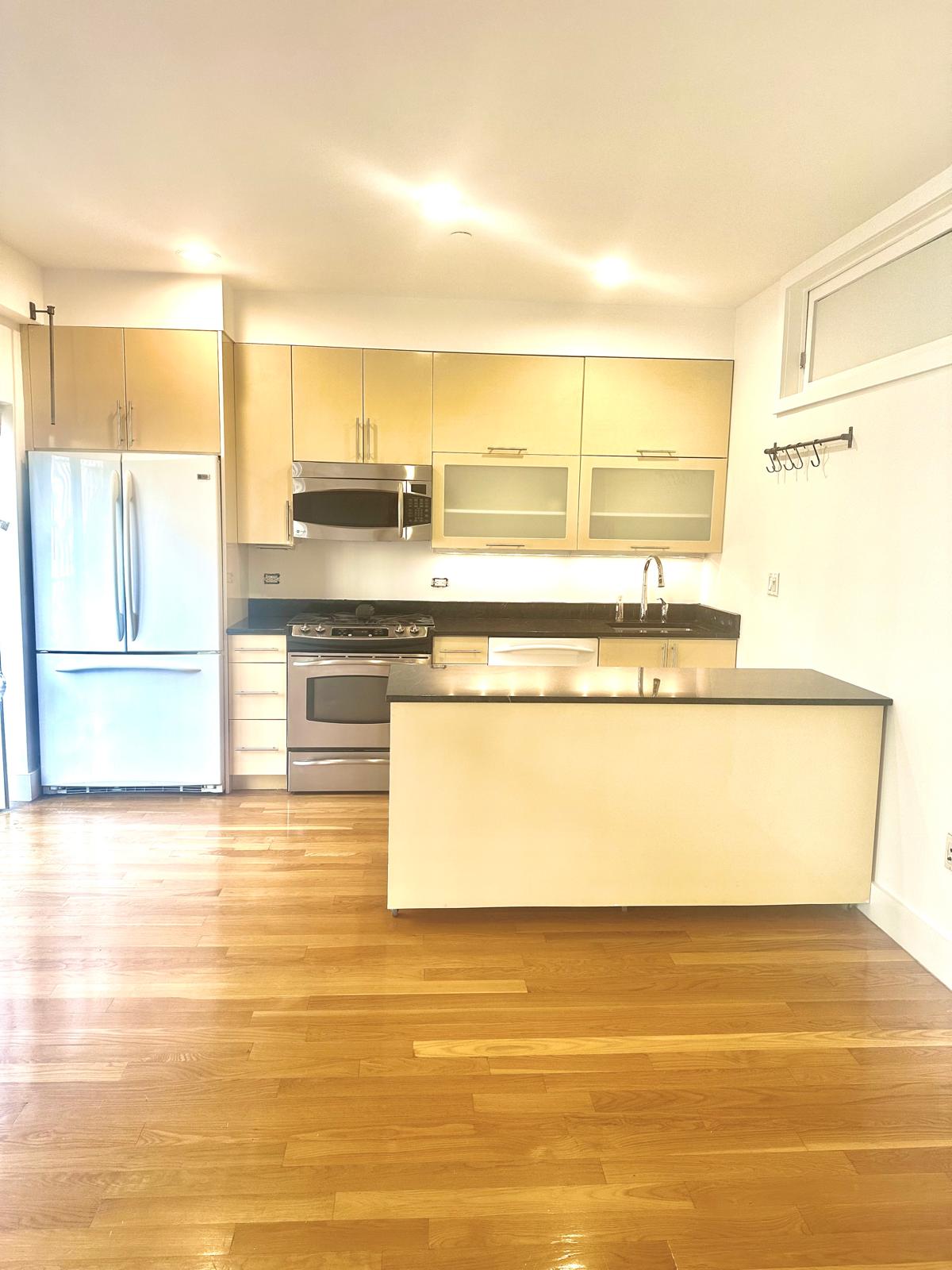221 West 148th Street, Unit 4A Manhattan, NY 10039 - Photo 3 of 11 a view of a kitchen with stainless steel appliances granite countertop a sink and a stove