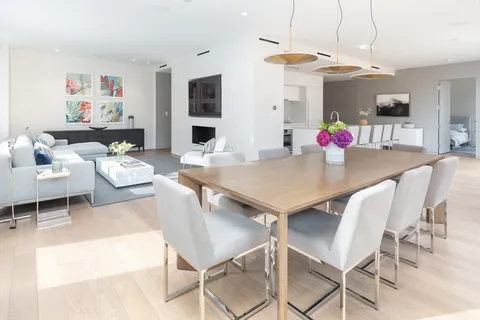 a view of a dining room with furniture and a kitchen view