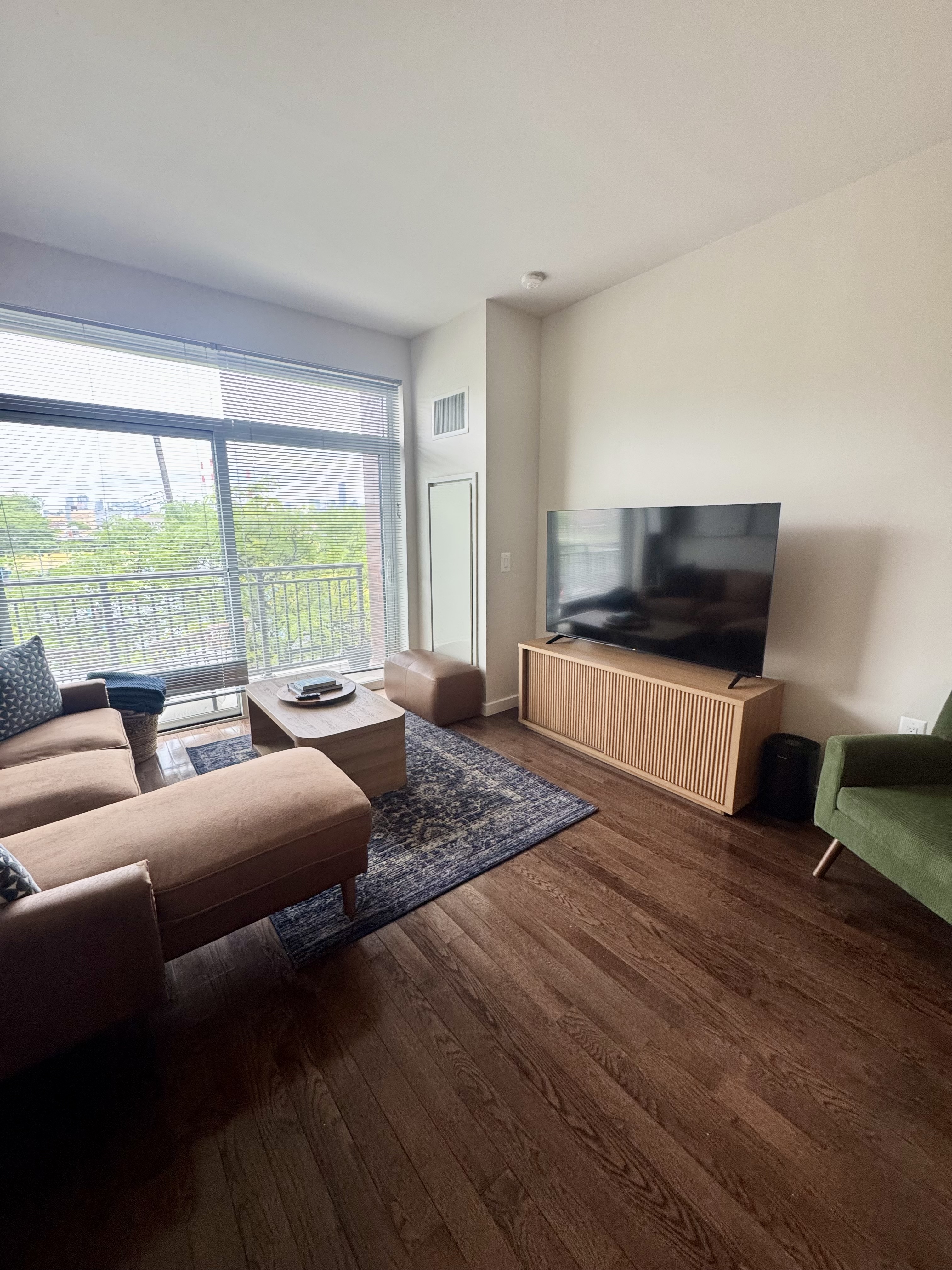 Broadway, Unit 306 Queens, NY 11106 - Photo 2 of 7 a bedroom with furniture and a flat screen tv
