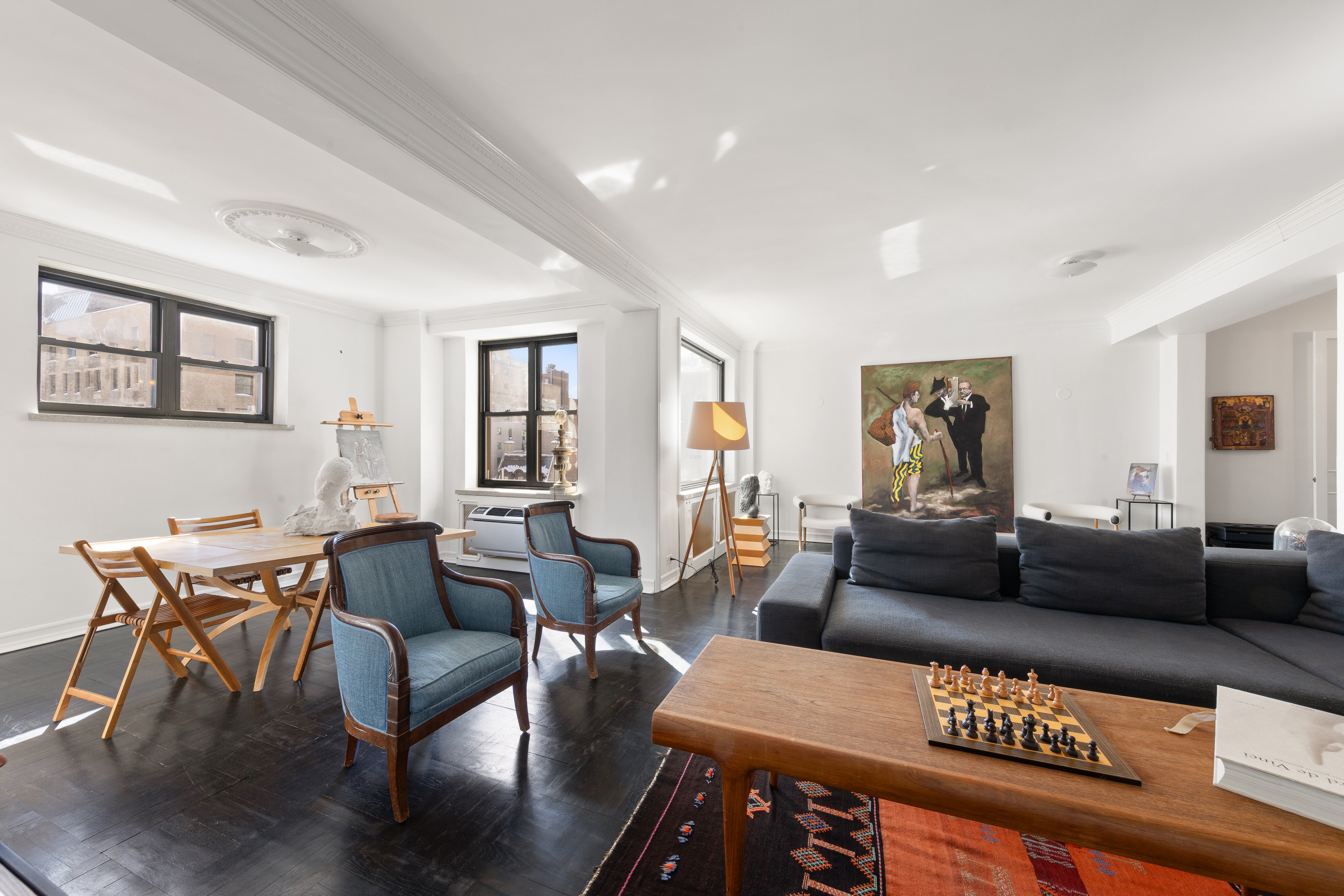 a living room with furniture and wooden floor