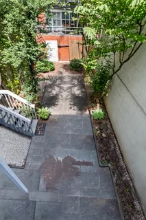 a view of a yard with potted plants