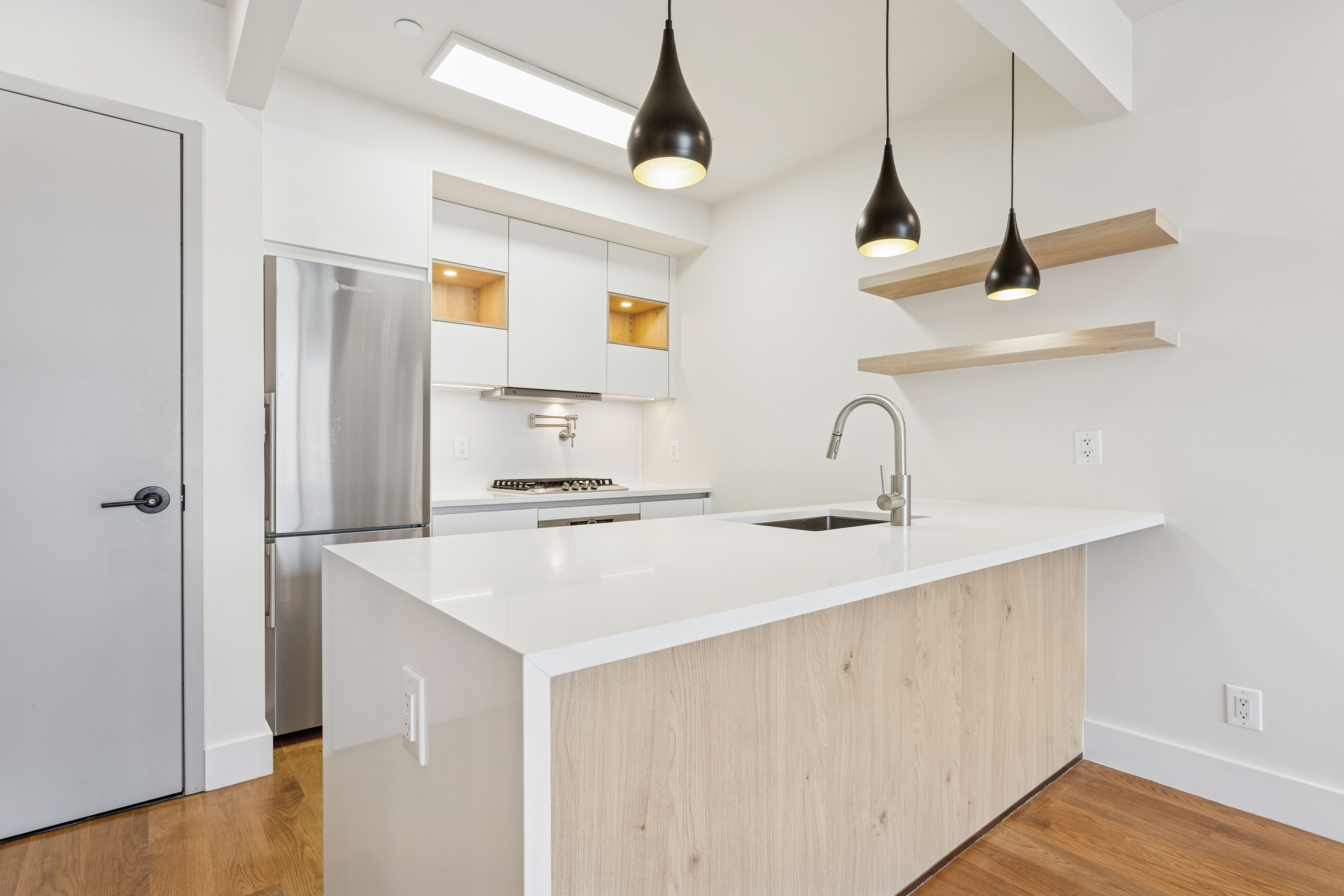 77 Kingsland Avenue, Unit 4F Brooklyn, NY 11211 - Photo 6 of 14 a kitchen with a sink a refrigerator and cabinets