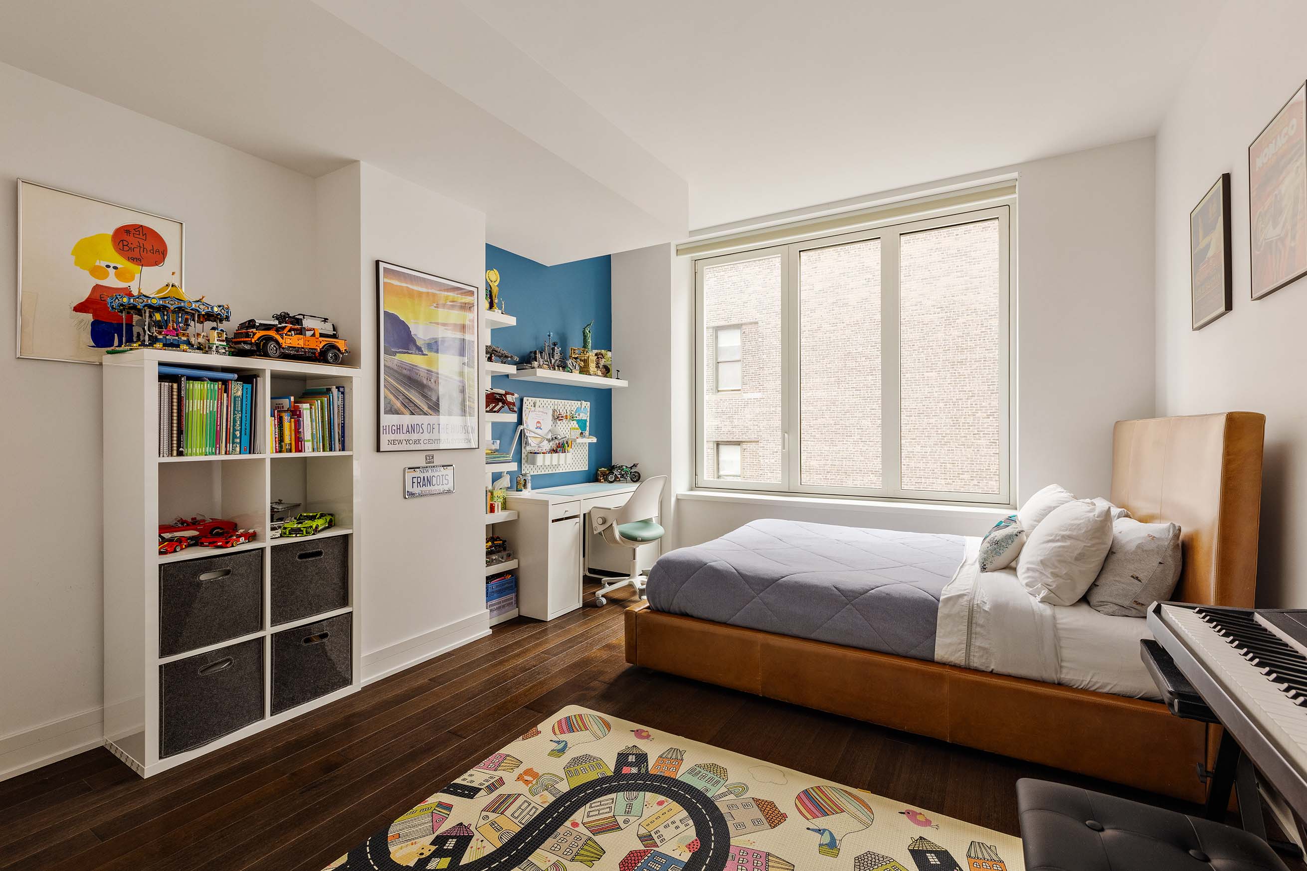 5 Franklin Place, Unit 14A Manhattan, NY 10013 - Photo 8 of 23 a bedroom with furniture and a book shelf