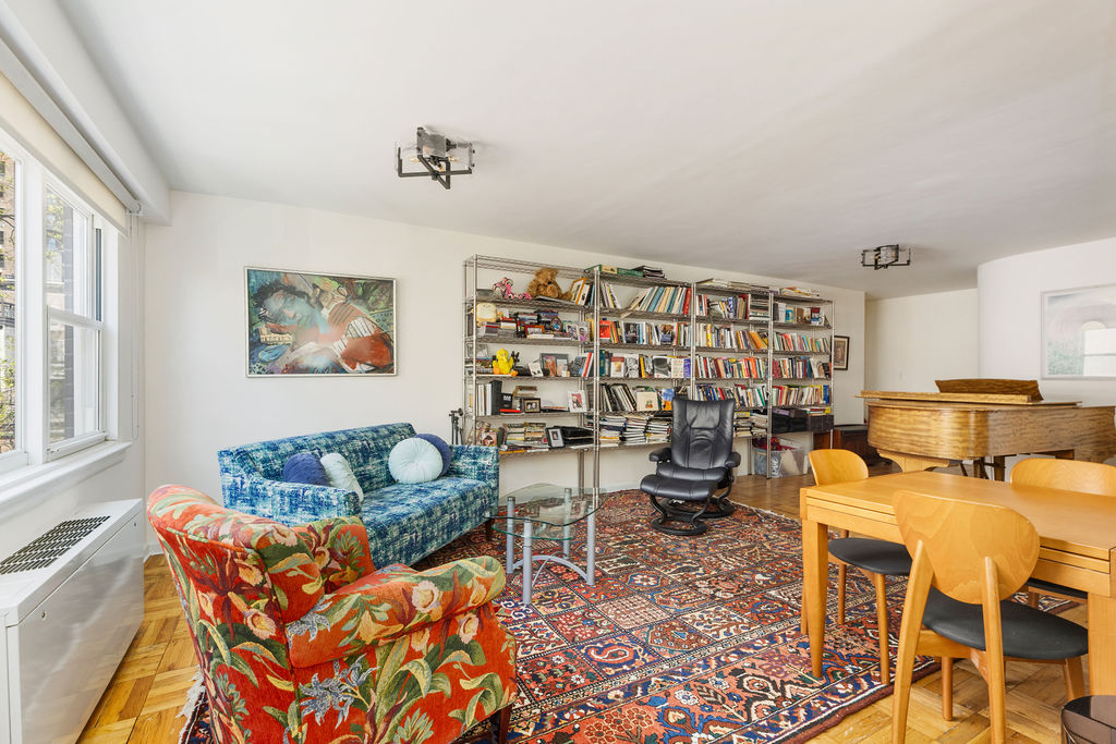101 West 12th Street, Unit 5V Manhattan, NY 10011 - Photo 12 of 26 a living room with furniture and a rug