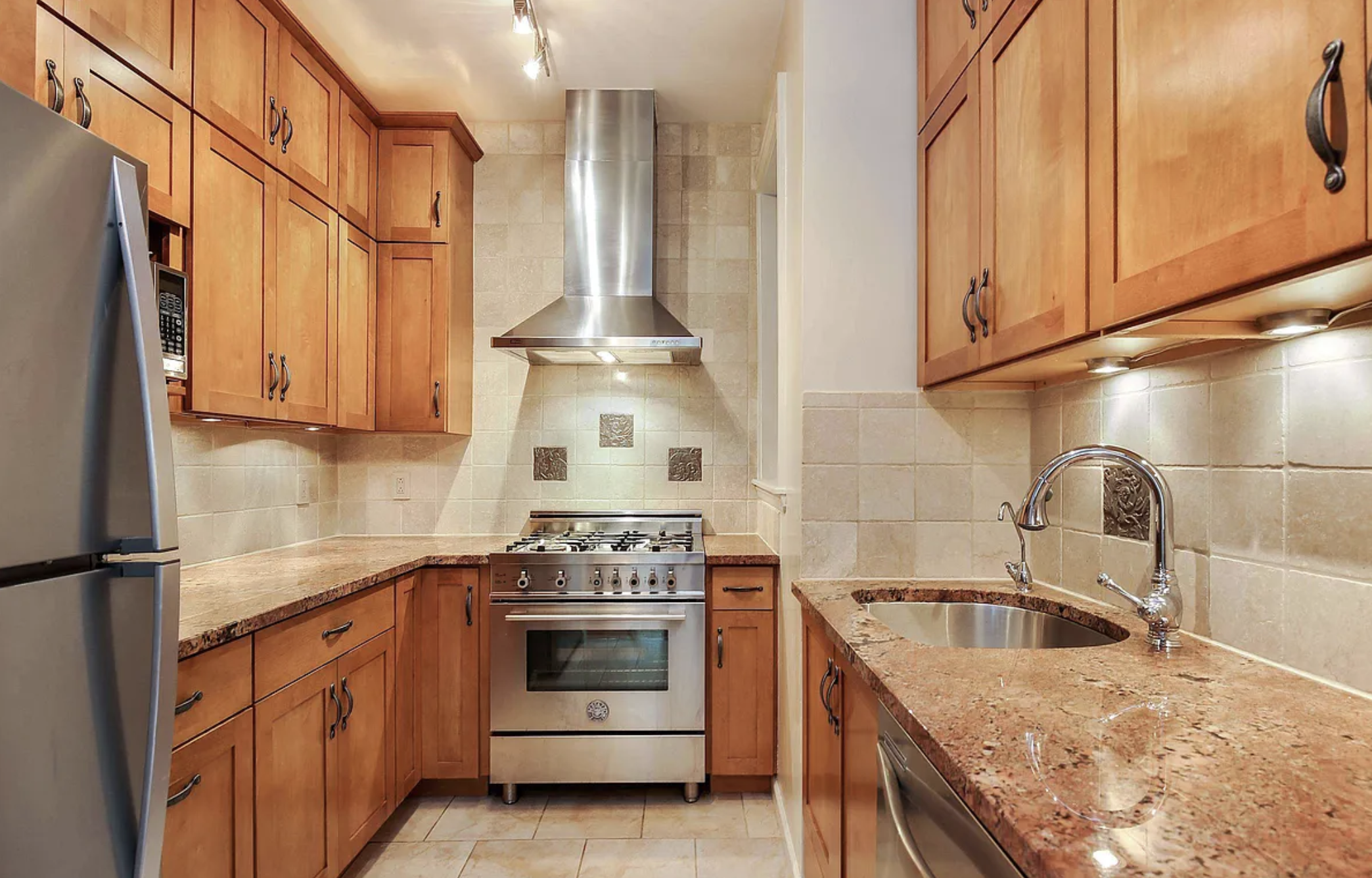 370 Convent Avenue, Unit 3B Manhattan, NY 10031 - Photo 1 of 12 a kitchen with stainless steel appliances granite countertop a sink a stove and a refrigerator