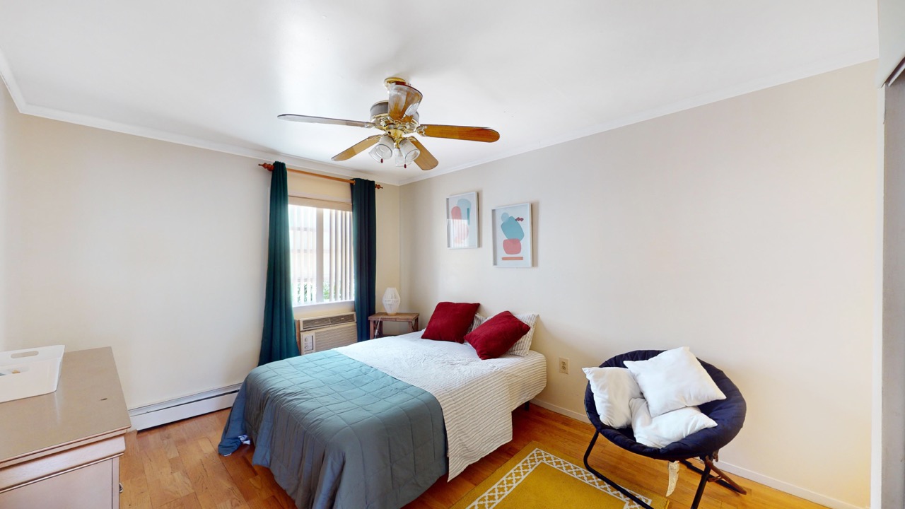 495 Central Avenue, Unit 2 Brooklyn, NY 11221 - Photo 7 of 19 a bedroom with a bed and a chandelier
