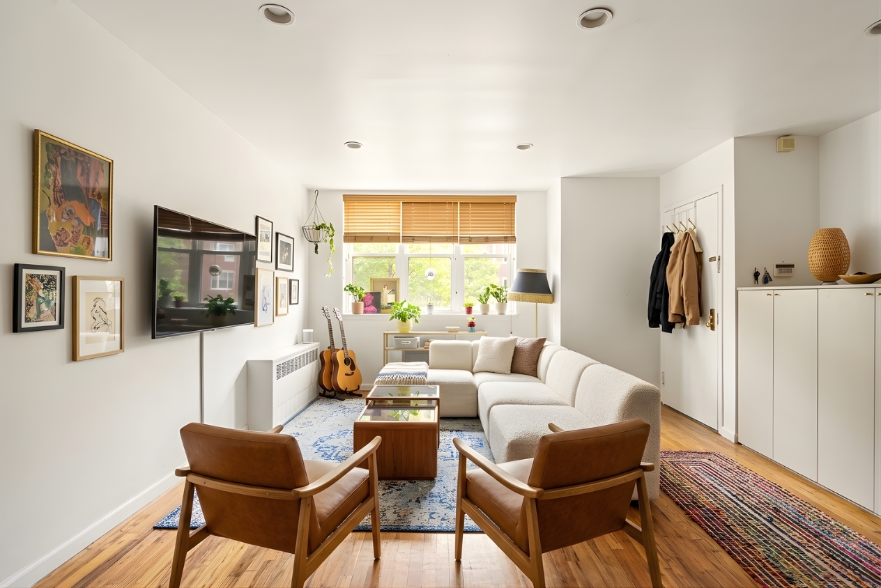 109 Pulaski Street Brooklyn, NY 11206 - Photo 3 of 14 a living room with furniture a flat screen tv and a window