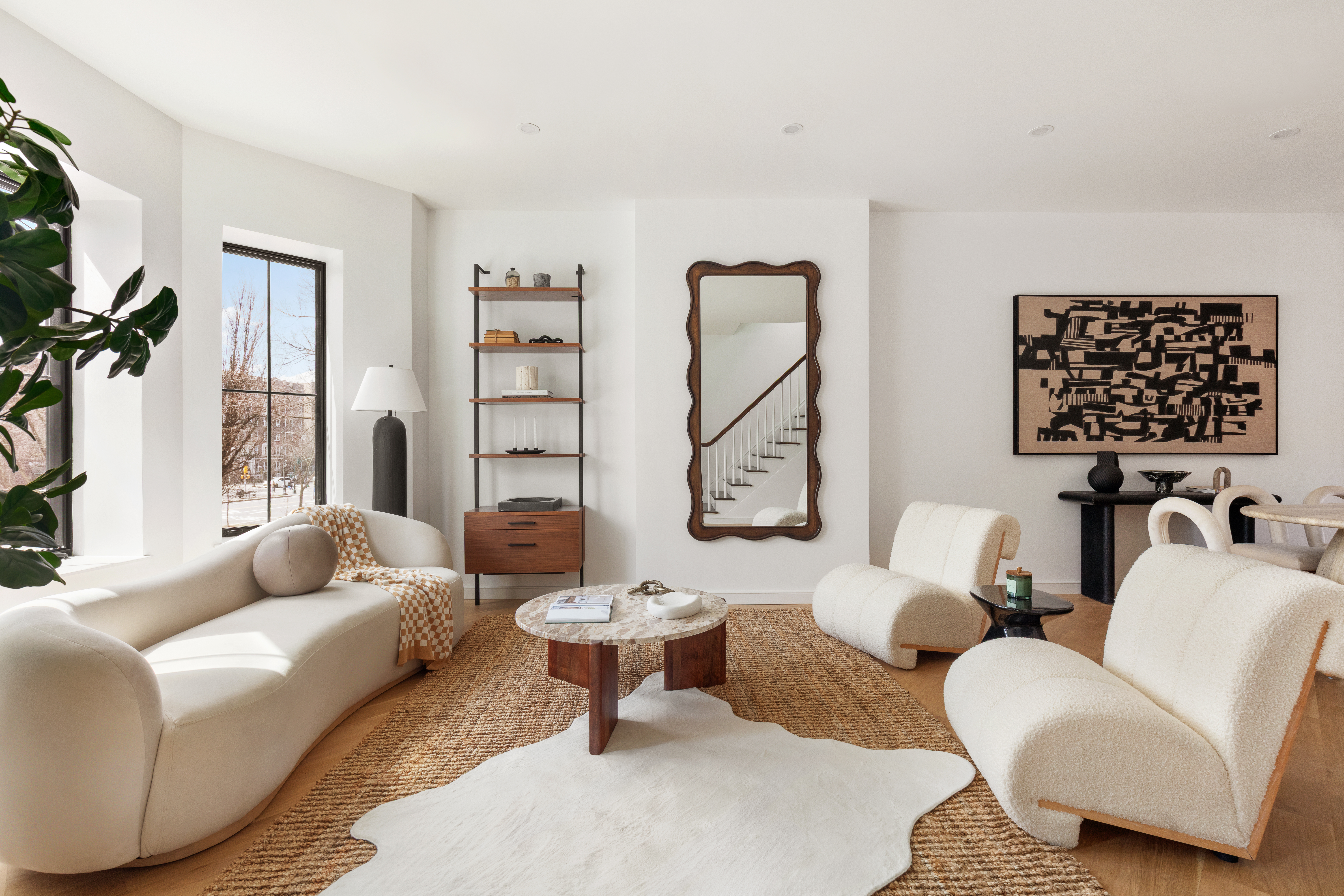 a living room with furniture a rug and a painting on the wall