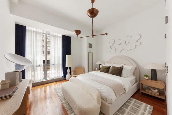 a bedroom with a bed and a chandelier