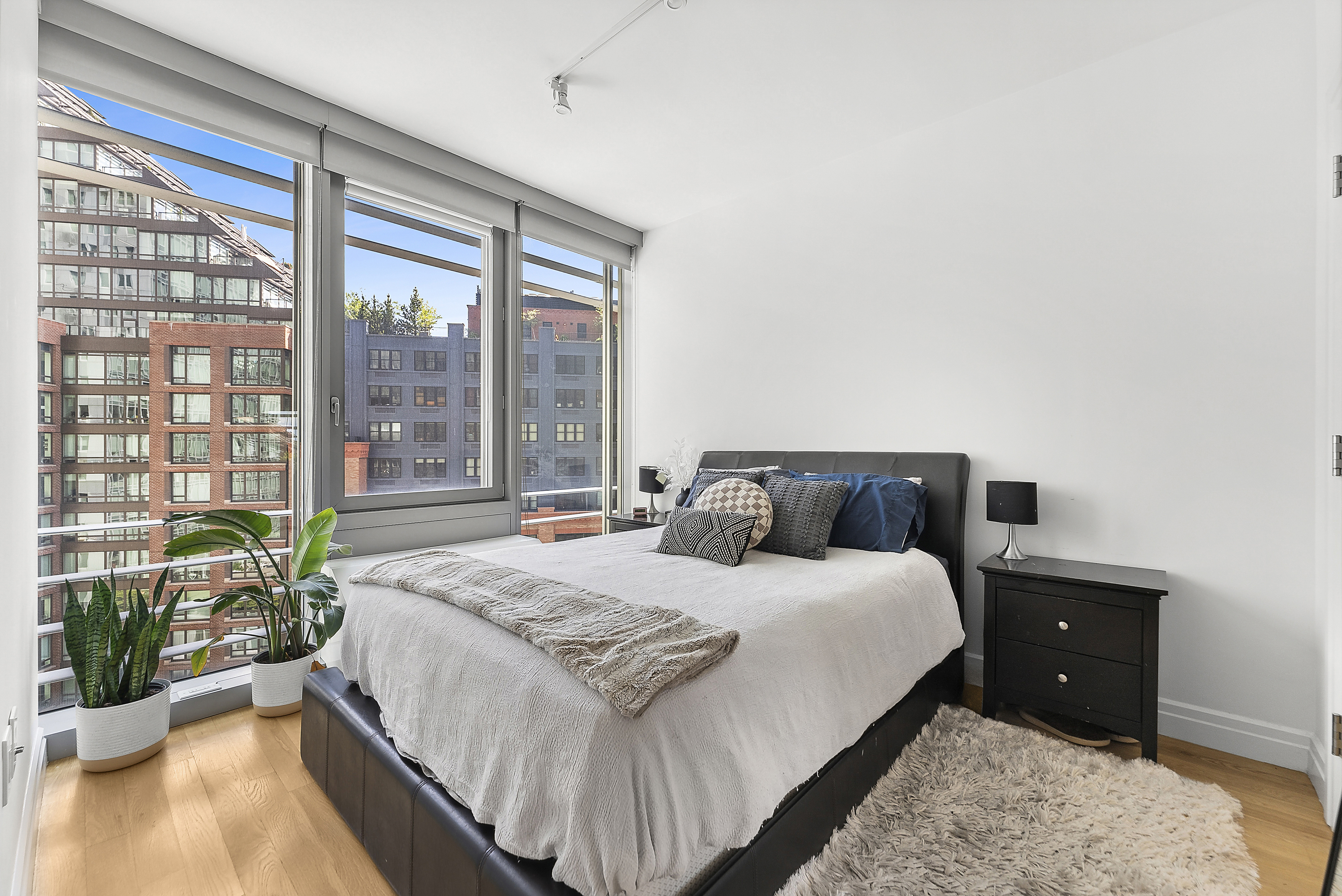 550 West 54th Street, Unit 1030 Manhattan, NY 10019 - Photo 1 of 5 a bedroom with a bed and a large window