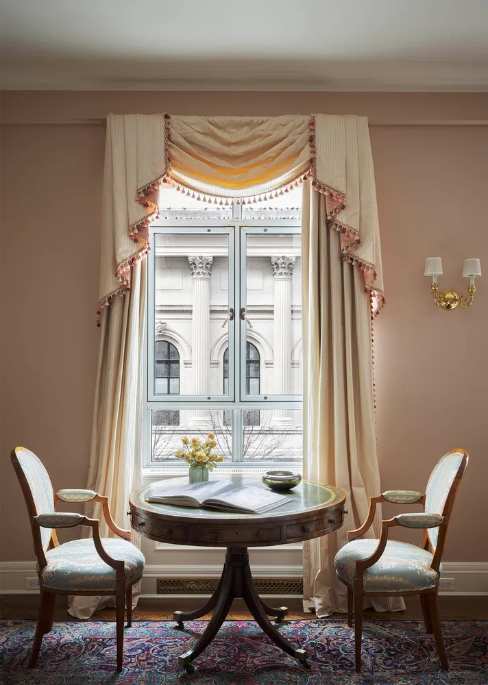 a view of a dining room with furniture and a window