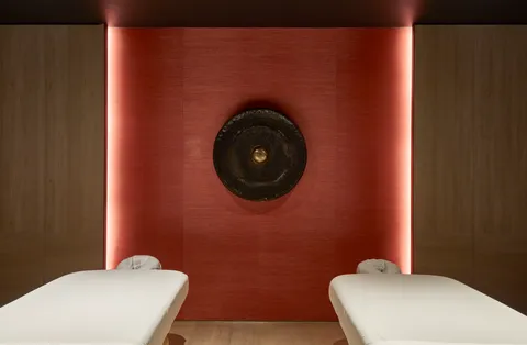 a bathroom with a toilet and a mirror