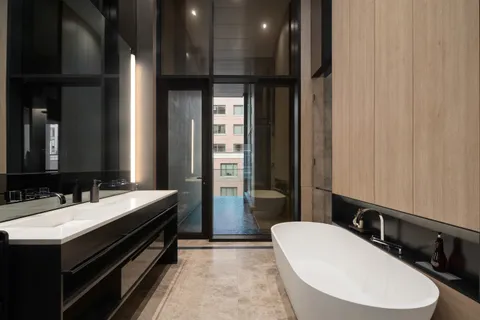 a bathroom with a double vanity sink and a mirror