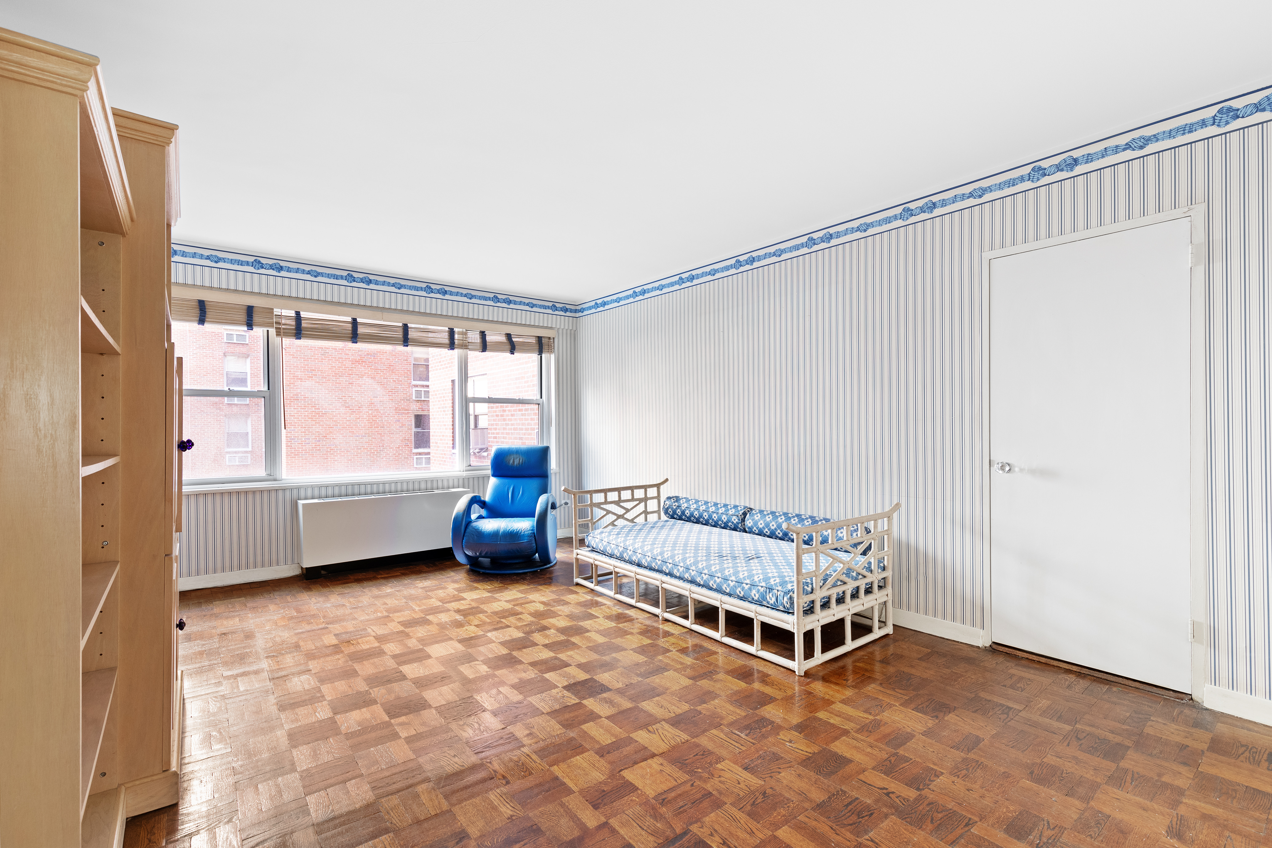 50 Sutton Place South, Unit 7A Manhattan, NY 10022 - Photo 13 of 16 a living room with a bed and a window