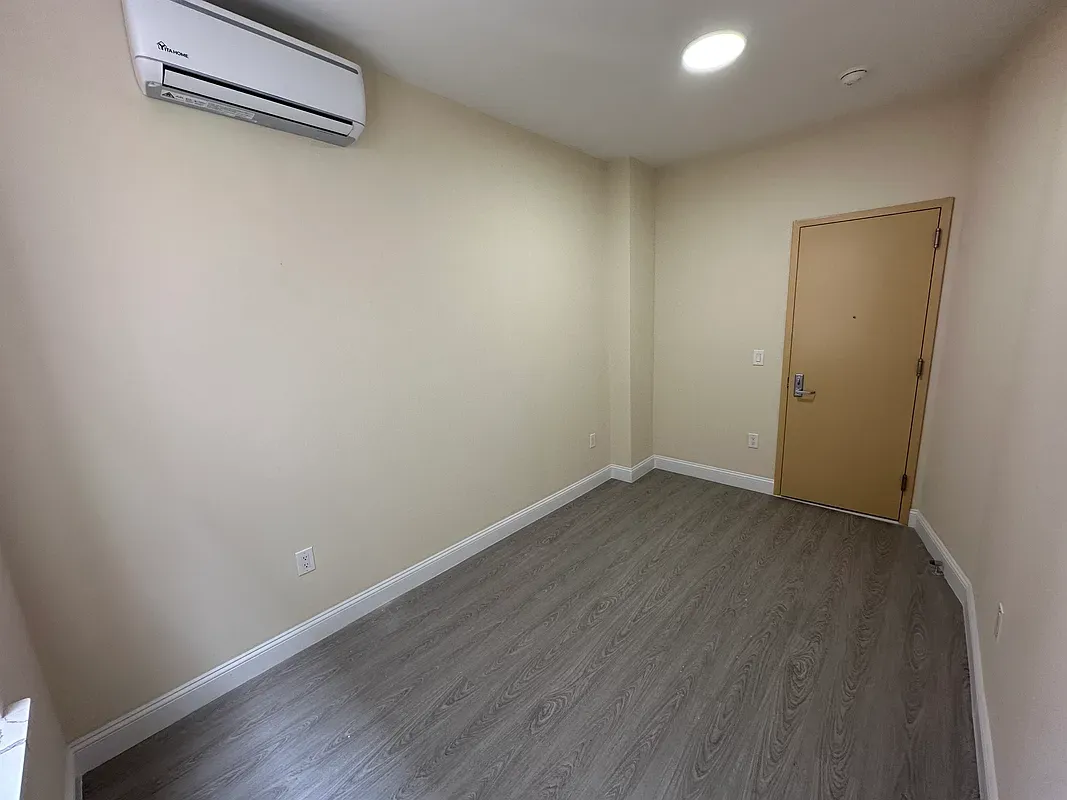 a view of a room with wooden floor