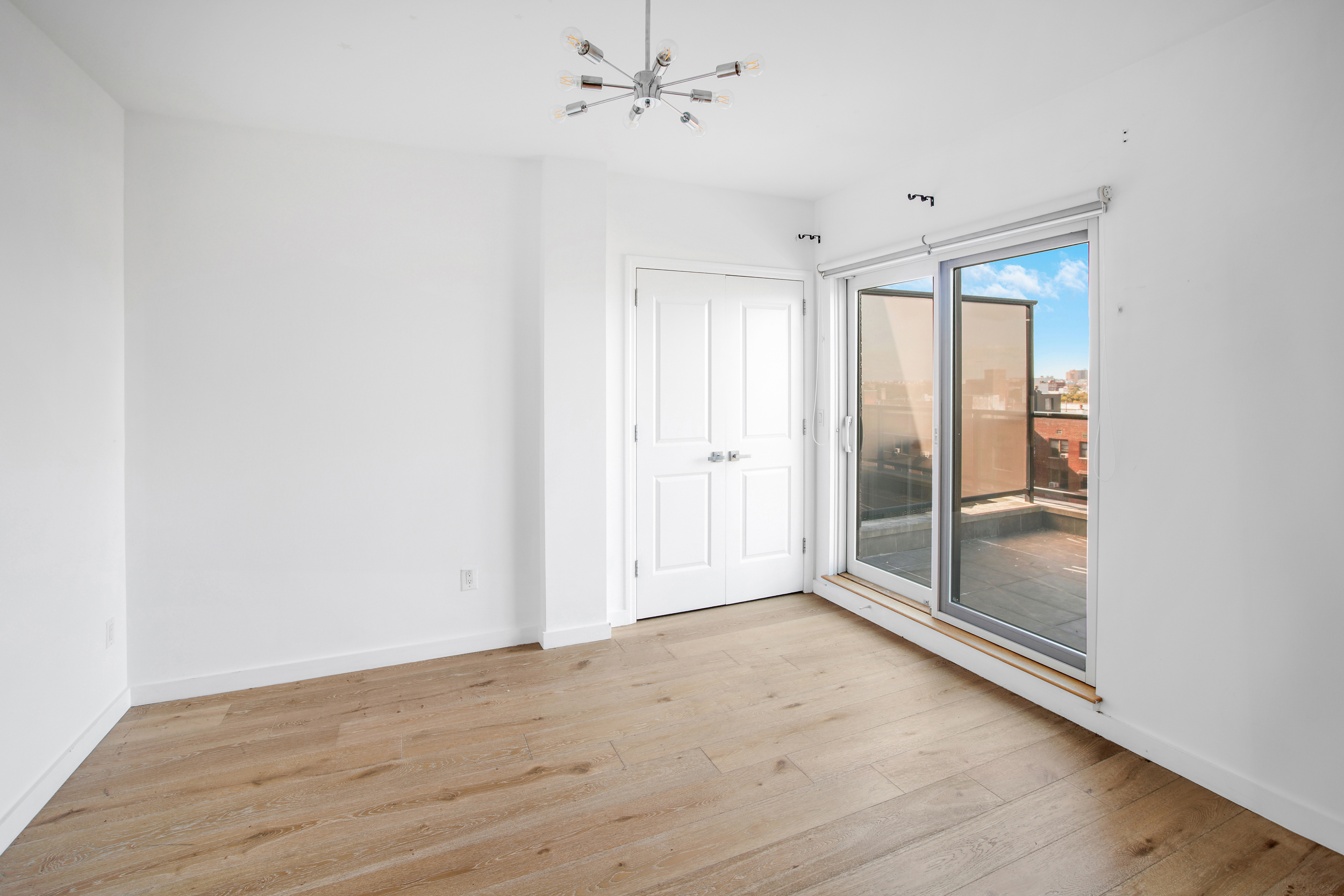 3041 Ocean Avenue, Unit PH4 Brooklyn, NY 11235 - Photo 11 of 18 wooden floor in an empty room with a window