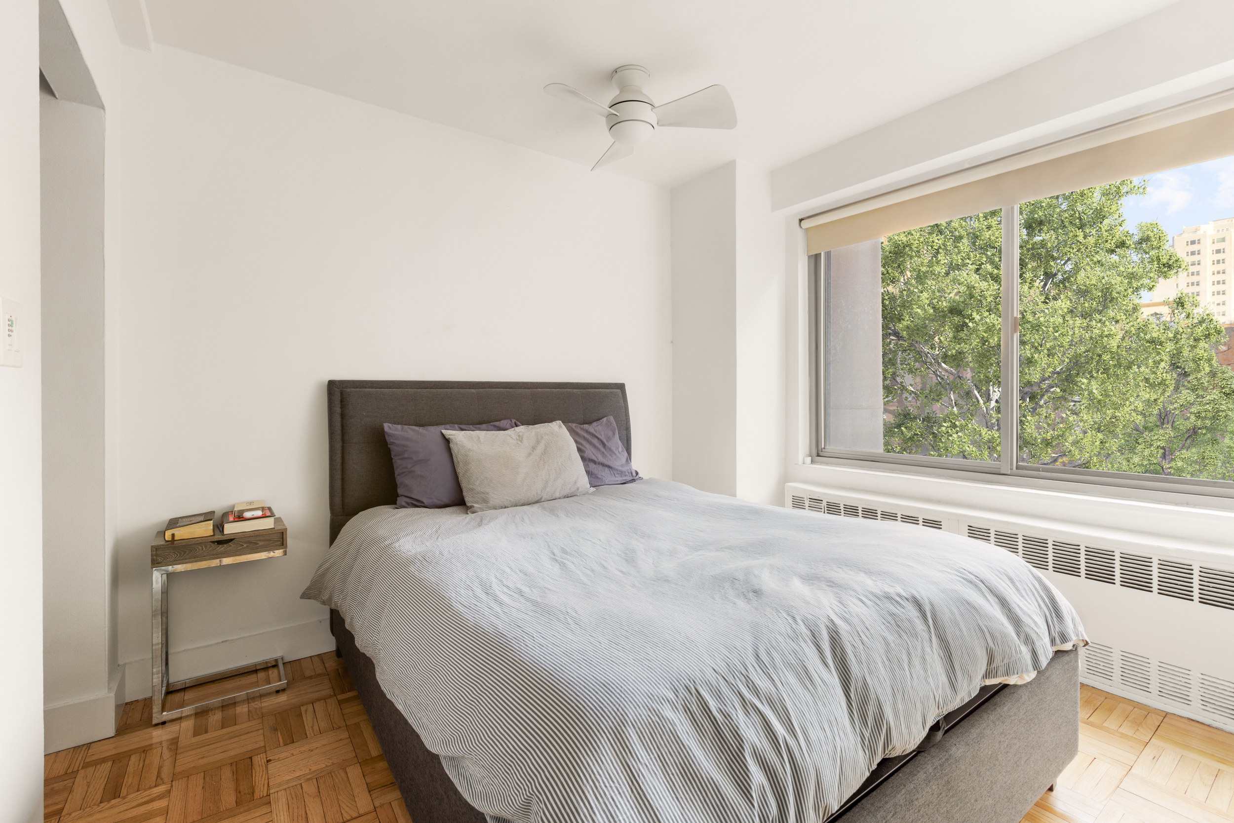 175 West 12th Street, Unit 5M Manhattan, NY 10011 - Photo 5 of 10 a bedroom with a bed and a window