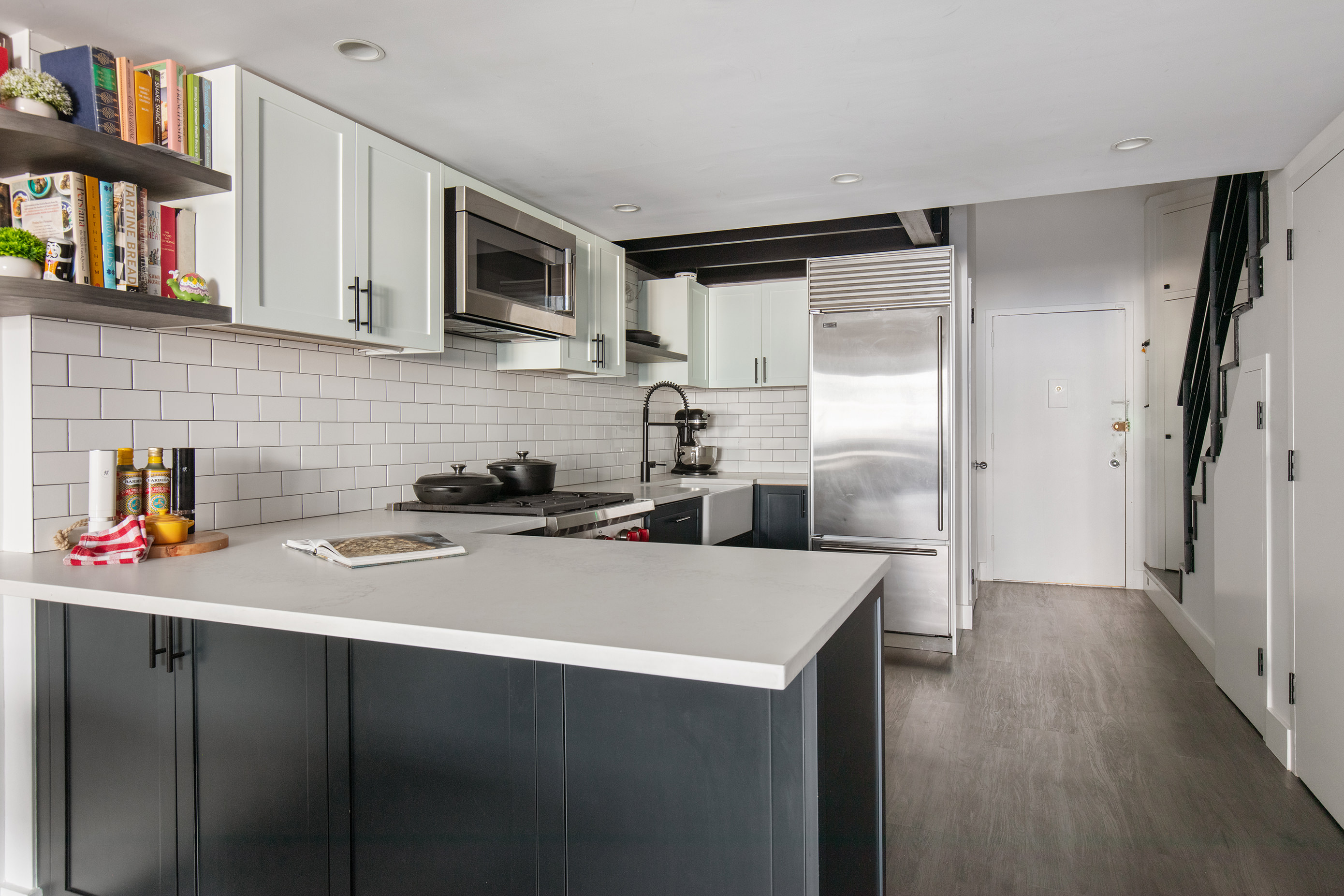 372 5th Avenue, Unit 5L Manhattan, NY 10018 - Photo 4 of 6 a kitchen with stainless steel appliances a refrigerator sink and cabinets