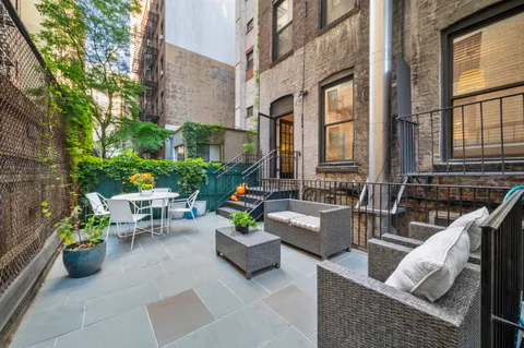 a view of a patio with couches and potted plants