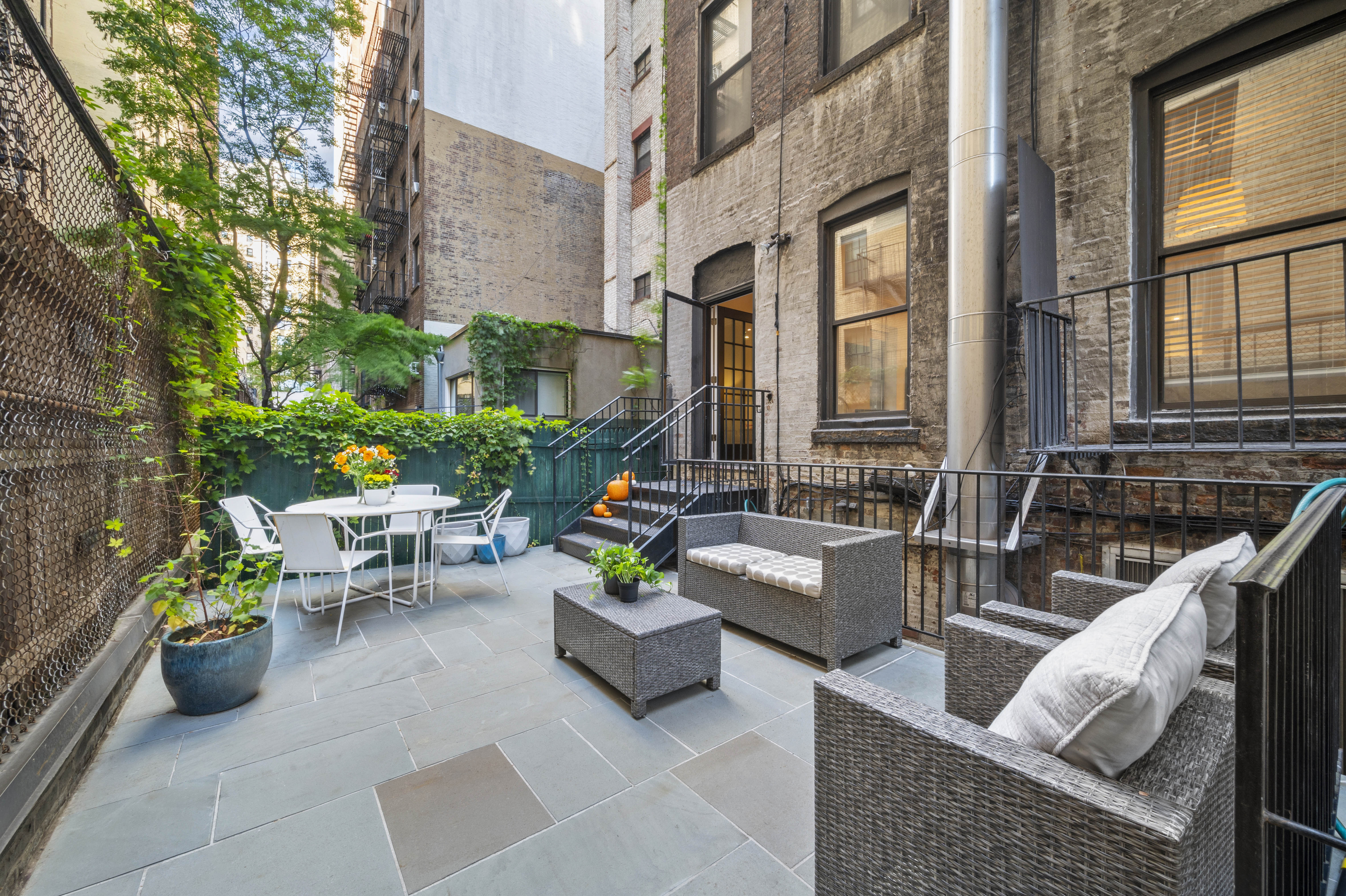 a view of a patio with couches and potted plants