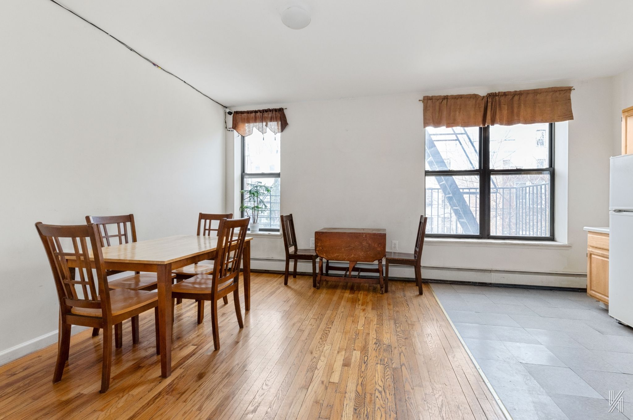 426 54th Street Brooklyn, NY 11220 - Photo 7 of 22 a dining room with a wooden table and chairs