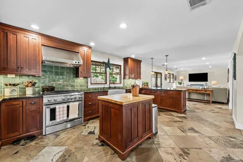 a bathroom with a double vanity sink mirror and bathtub