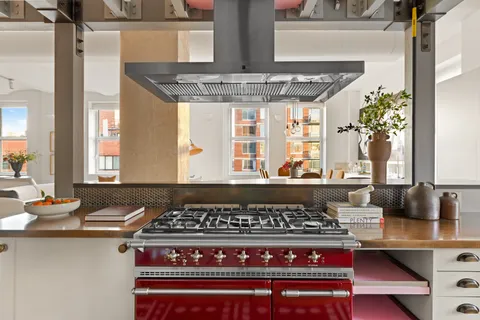 a kitchen with stainless steel appliances granite countertop a stove and a sink