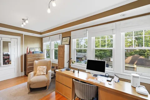a living room with furniture and large windows