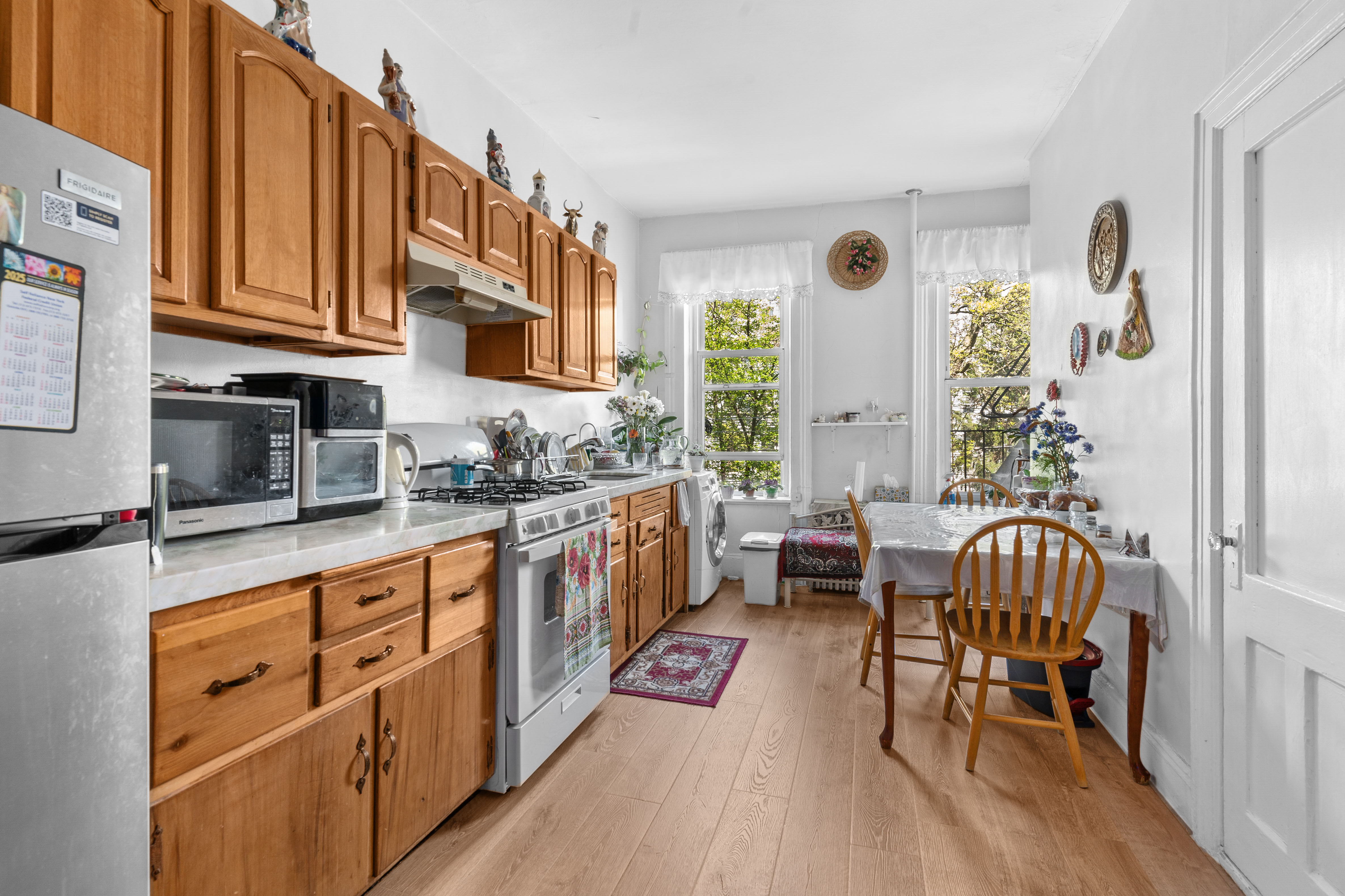 139 North 8th Street Brooklyn, NY 11249 - Photo 7 of 15 a open kitchen with stainless steel appliances granite countertop a stove a sink and a refrigerator