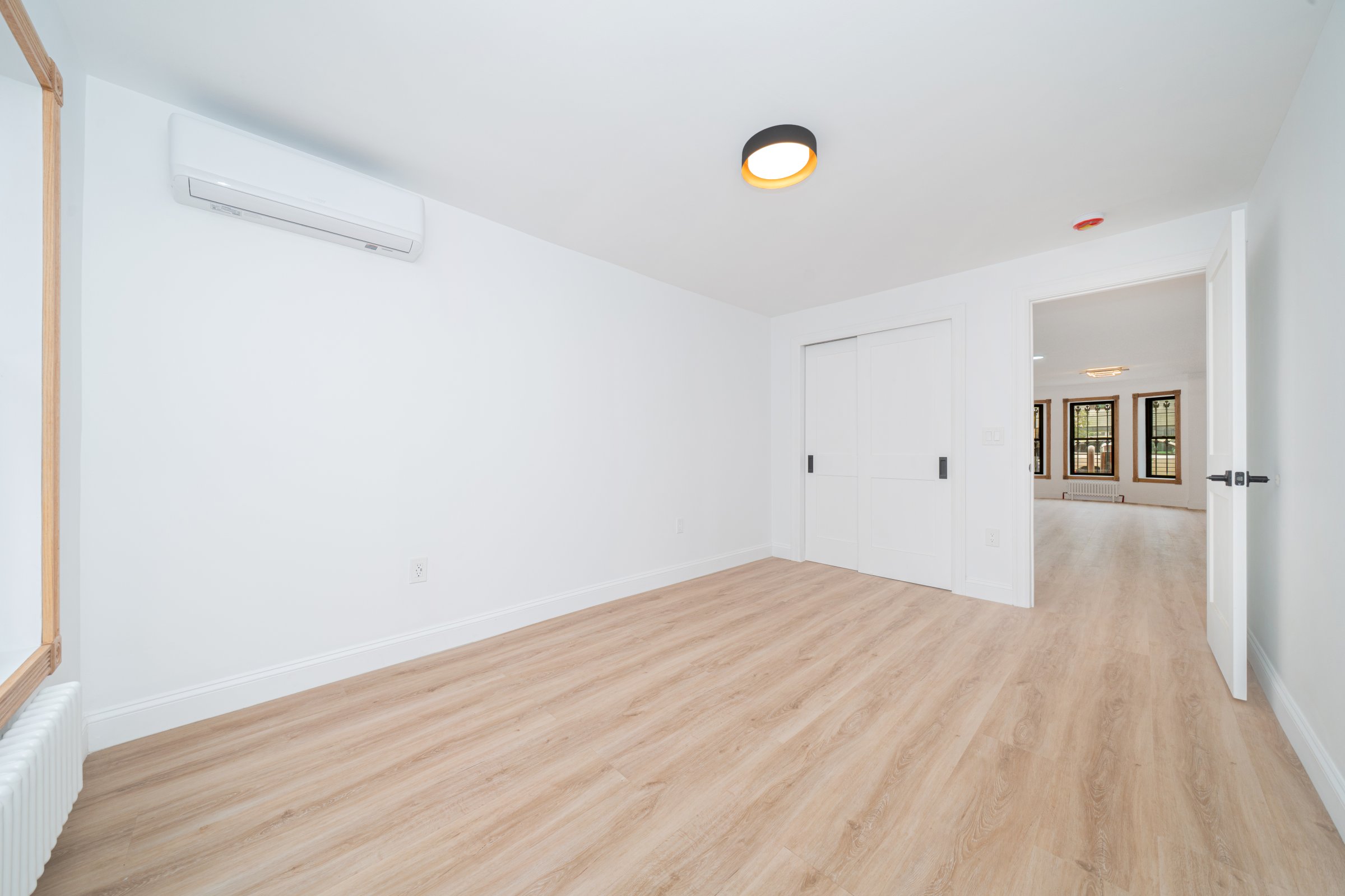 248 Eldert Street, Unit 1 Brooklyn, NY 11207 - Photo 9 of 12 a view of empty room with wooden floor