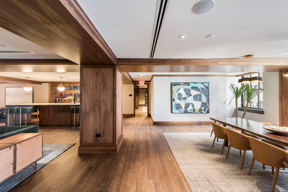 100 Barclay Street, Unit 13P Manhattan, NY 10007 - Photo 13 of 21 a view of a hallway with furniture and wooden floor