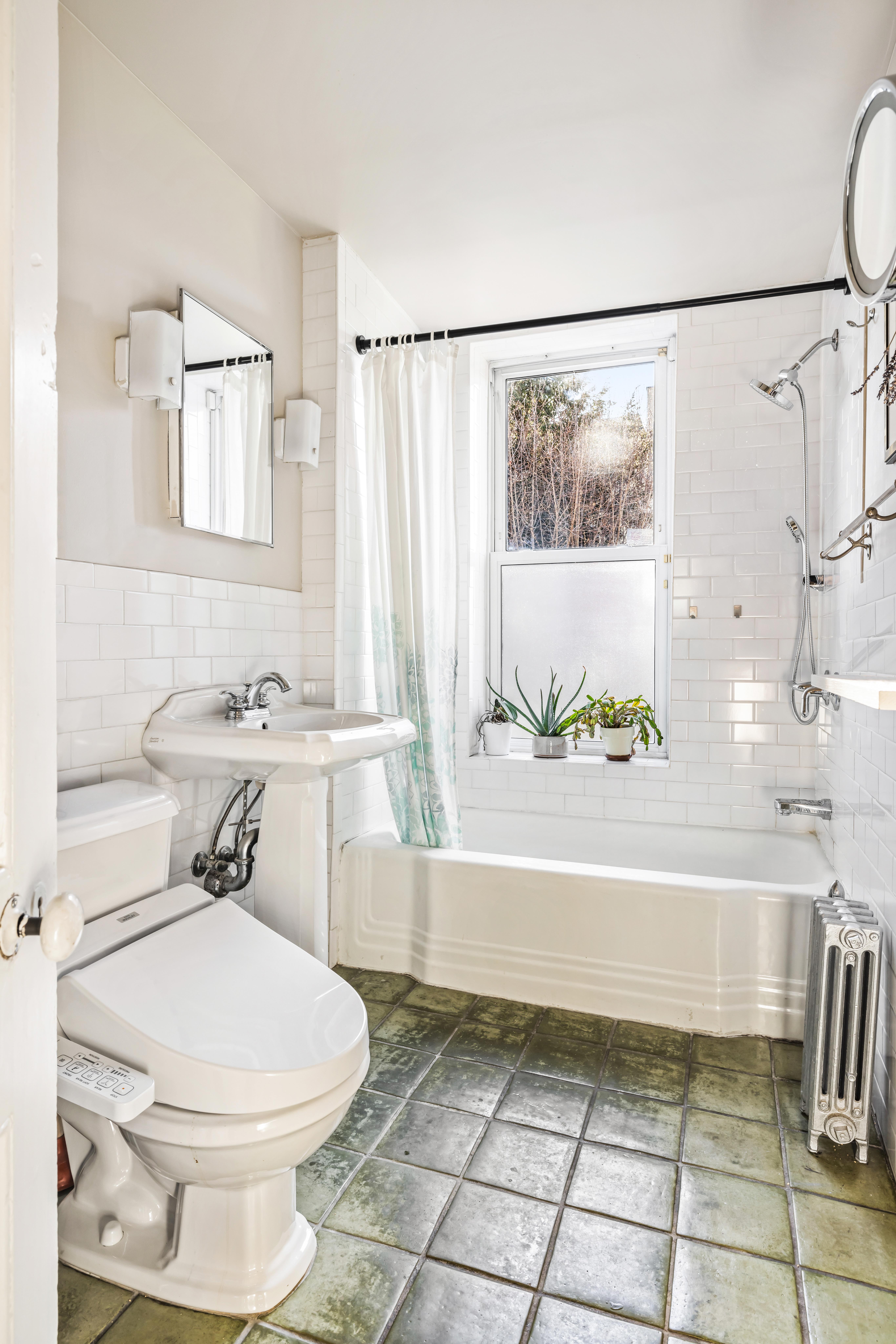 226 11th Street, Unit 2 Brooklyn, NY 11215 - Photo 14 of 19 a bathroom with a toilet a sink and a bathtub
