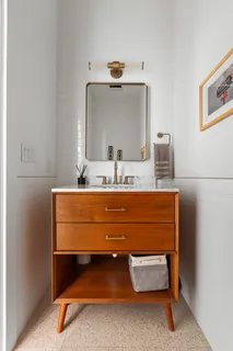 a bathroom with a sink vanity and mirror
