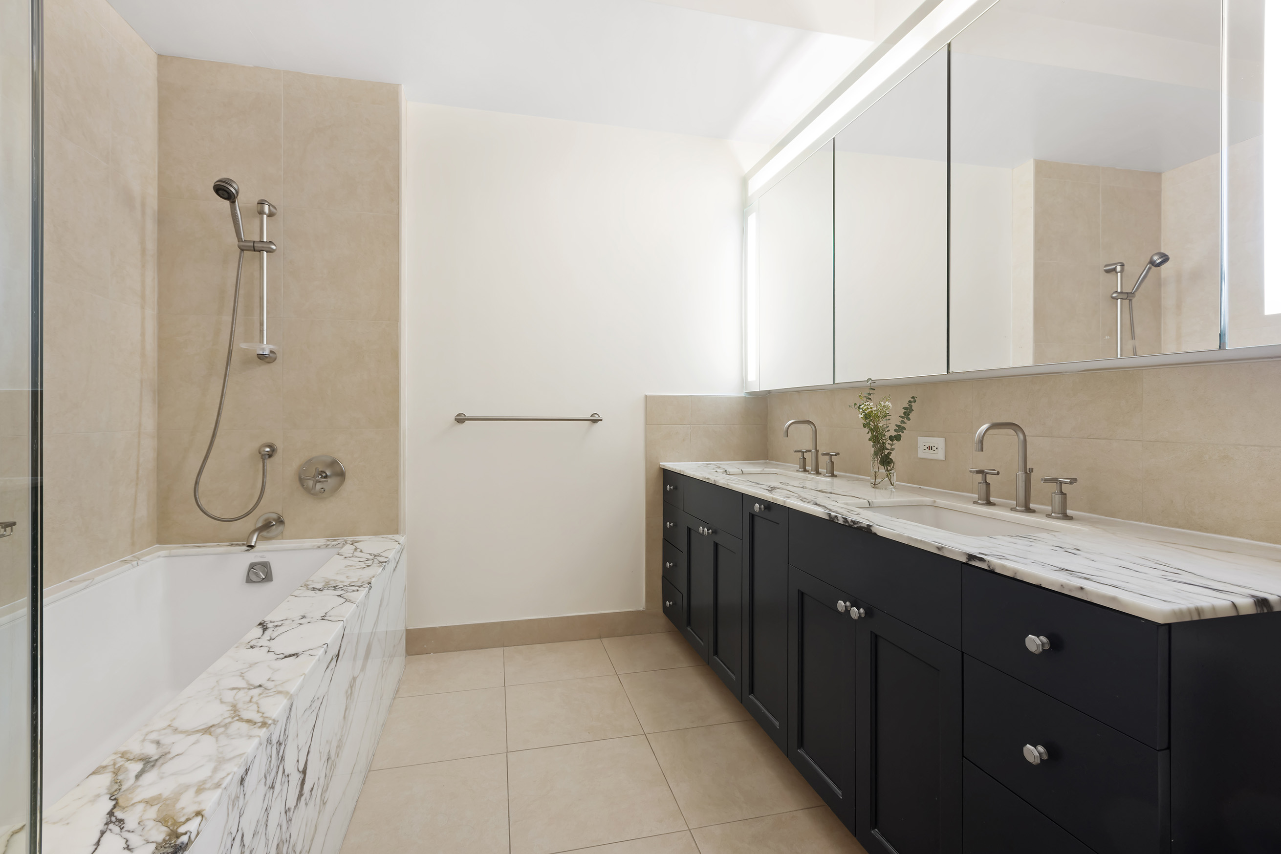 9 College Place, Unit 2K Brooklyn, NY 11201 - Photo 10 of 17 a bathroom with a sink double vanity granite tub shower and a mirror