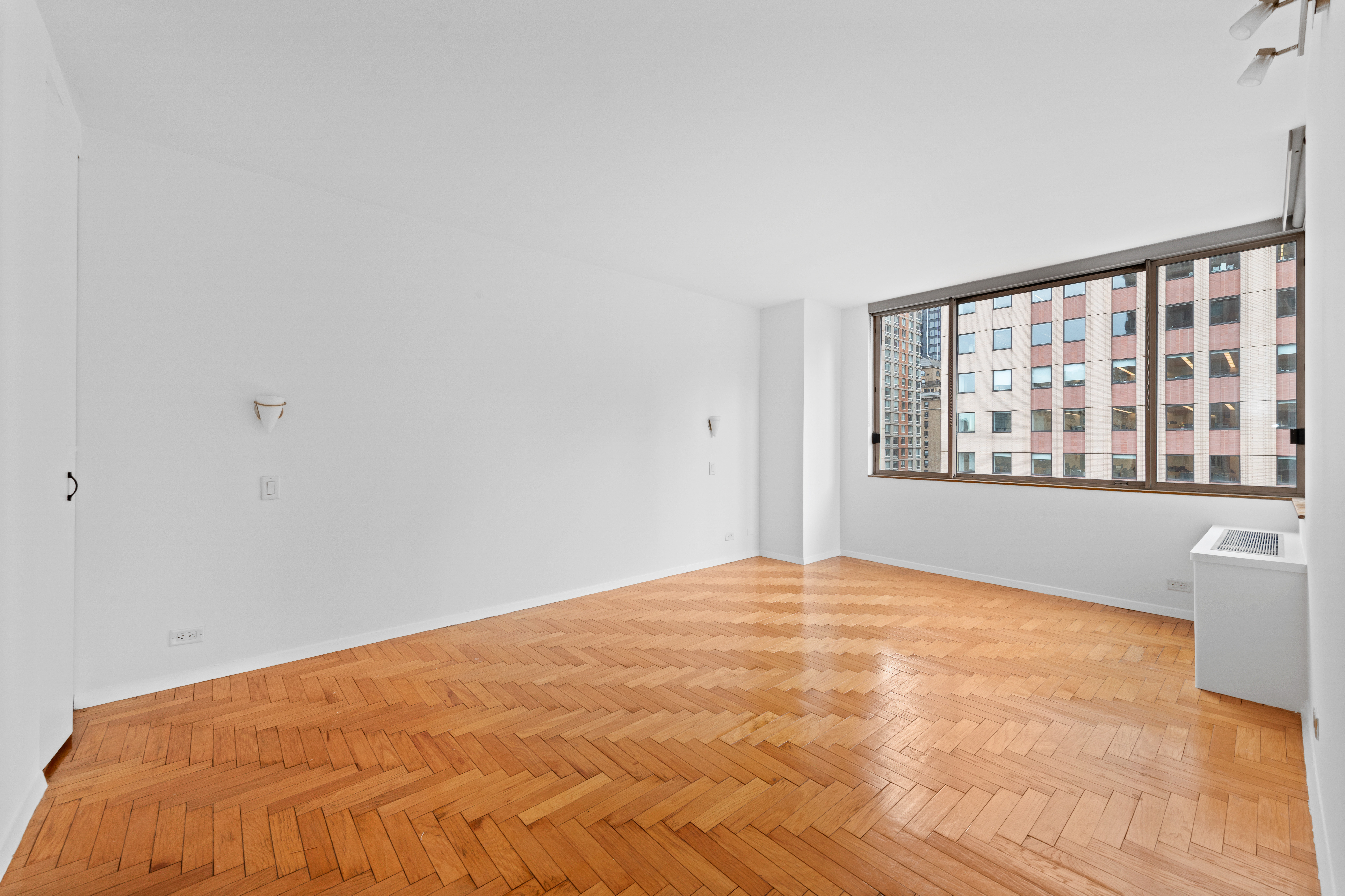 350 West 50th Street, Unit 12B Manhattan, NY 10019 - Photo 6 of 16 a view of an empty room with a window