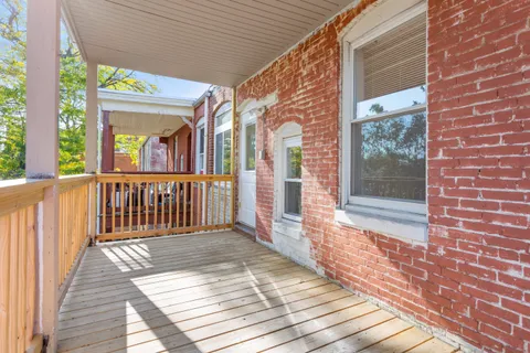 a view of a brick house with wooden floor and floor to ceiling window