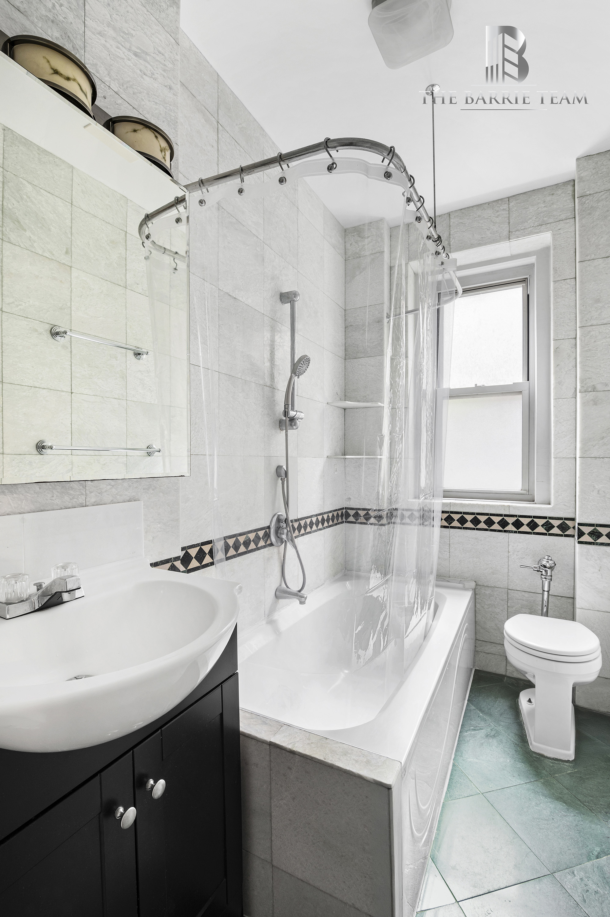 203 West 81st Street, Unit 3E Manhattan, NY 10024 - Photo 5 of 6 a bathroom with a sink mirror toilet and bathtub